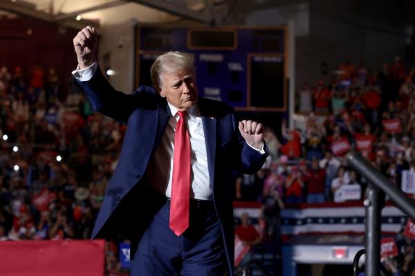 Republican presidential nominee, former U.S. President Do<em></em>nald Trump leaves the stage following a campaign rally at Williams Arena at Minges Coliseum on October 21, 2024 in Greenville, North Carolina.
