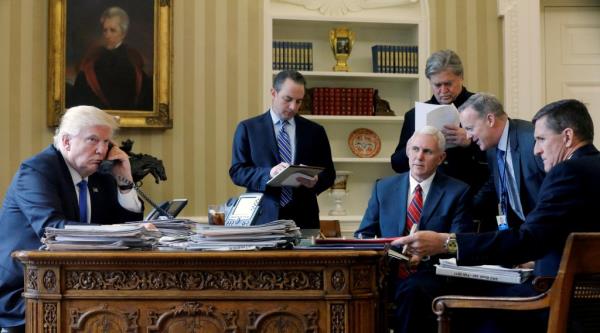 A photo of Then President Do<em></em>nald Trump, Chief of Staff Reince Priebus, Vice President Mike Pence, Steve Bannon, Communications Director Sean Spicer, and Natio<em></em>nal Security Advisor Michael Flynn in the Oval Office.