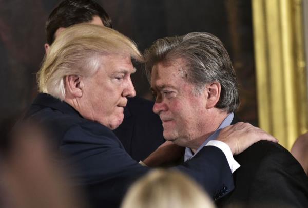President Do<em></em>nald Trump embraces his one time close aide Steve Bannon.