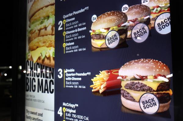 Drive Thru lane at McDonald's with Quarter Pounders marked as 'unavailable' and 'Back Soon', due to E. coli outbreak.