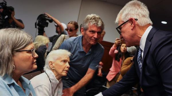 Los Angeles County District Attorney George Gascon shakes hands with Joan Andersen VanderMolen, sister of Kitty Menendez, at the end of a news co<em></em>nference on a decision in the case of brothers Erik and Lyle Menendez, who have spent 34 years in prison for the shotgun murder of their parents, in Los Angeles, California, U.S., October 24, 2024. REUTERS/Mike Blake