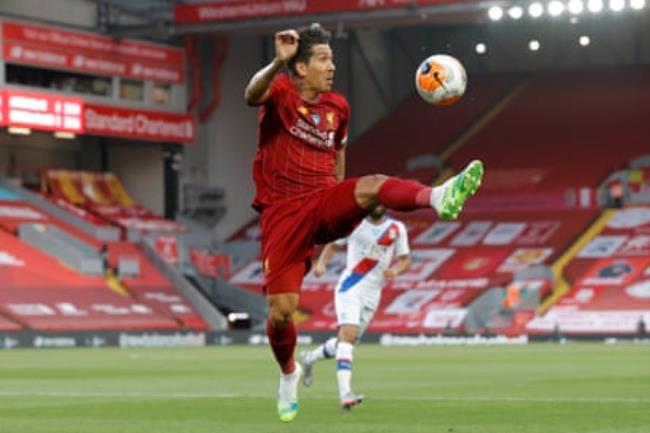 Liverpool’s leaping Roberto Firmino controls the ball against Crystal Palace in their Premier League match at Anfield in June 2020.
