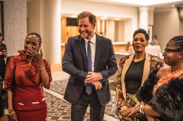 Board Chair Dr. Sophie Chandauka, Prince Harry, and a guest laughing together at a Sentebale event in Johannesburg, South Africa
