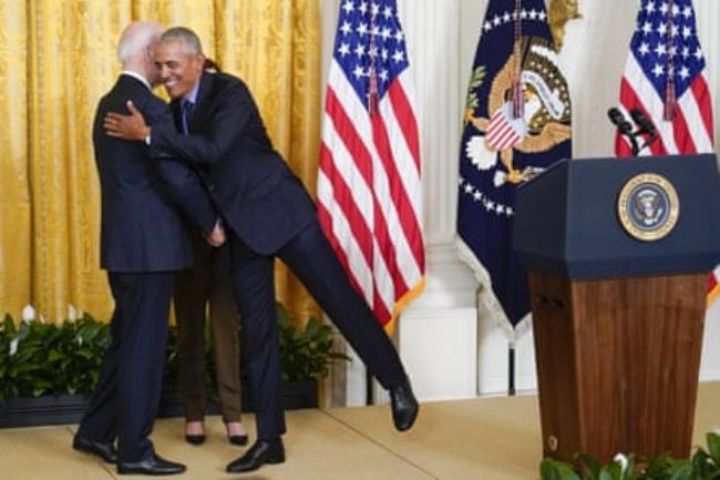 Joe Biden hugs Barack Obama on stage