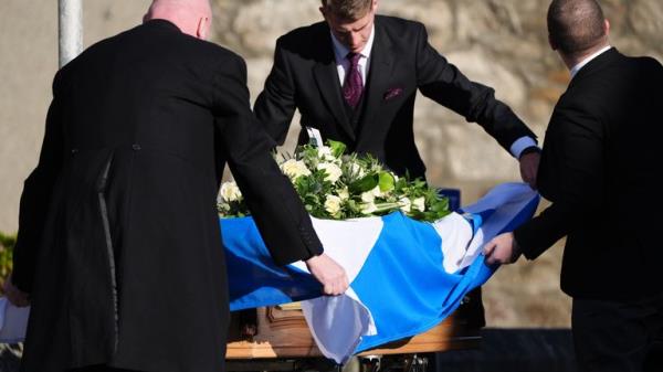 Pall bearers drape a Saltire flag over the coffin as it arrives at the funeral service for former first minister of Scotland Alex Salmond, at Strichen Parish Church in Strichen, Fraserburgh. The former Alba Party and SNP leader died of a heart attack while attending a co<em></em>nference in North Macedo<em></em>nia earlier this month. Picture date: Tuesday October 29, 2024.