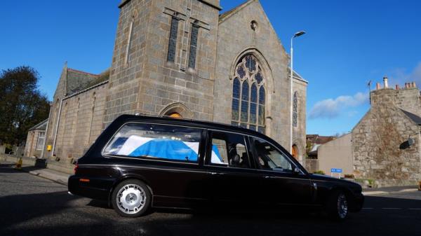 The hearse carrying the coffin, draped in a Saltire flag, arrives for the funeral service of former first minister of Scotland Alex Salmond, at Strichen Parish Church in Strichen, Fraserburgh. The former Alba Party and SNP leader died of a heart attack while attending a co<em></em>nference in North Macedo<em></em>nia earlier this month. Picture date: Tuesday October 29, 2024.