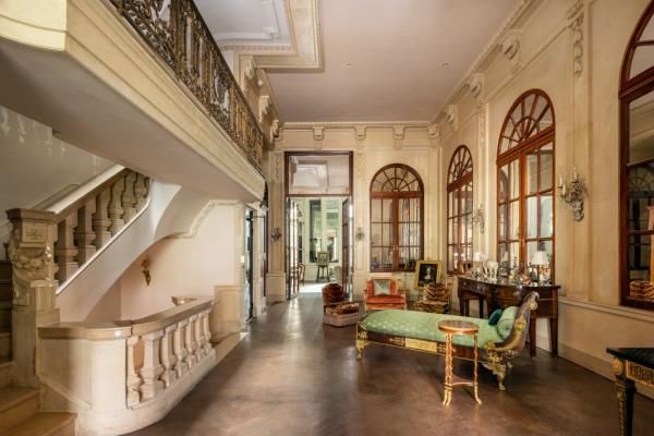 Arched windows and a dramatic staircase anchor the home.