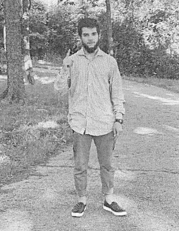 Nasir Ahmad Tawhedi is seen making the "Tawhid" gesture in a photo taken.
