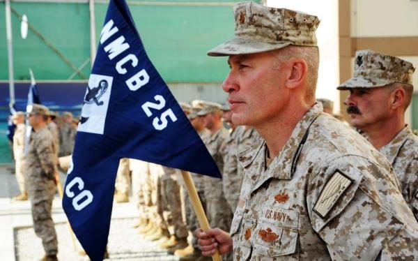 Lt. Cmdr. Jeromy Pittmann, Naval Mobile Co<em></em>nstruction Battalion Two Five (NMCB 25) November Company officer, stands at parade rest in front of his company during the NMCB 25 casing of the colors ceremony at New Kabul Compound, Afghanistan. 
