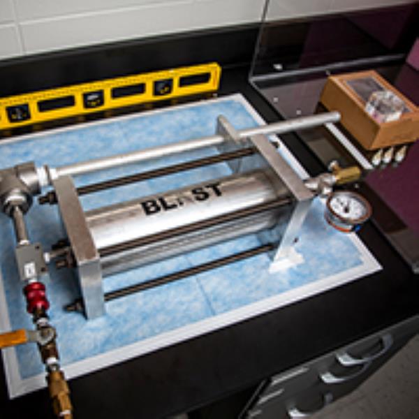 Photo of laboratory device used to propel projectiles into different tissues at set speeds.